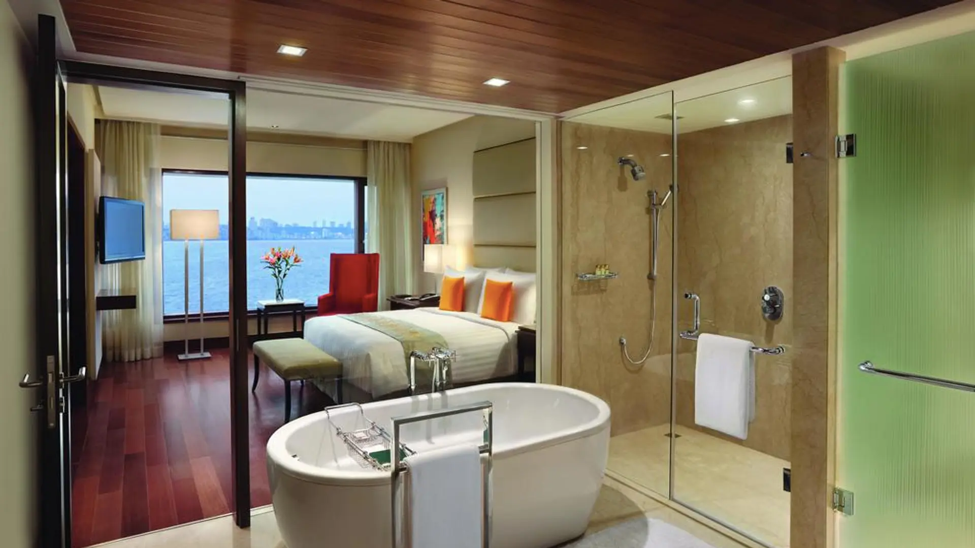 Hotel room at The Oberoi Mumbai with bathroom and bedroom